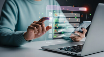 Person interacting with a digital checklist on a translucent screen near a laptop and a smartphone