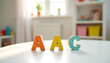 © Autism in Focus - AAC colorful plastic letters on table representing augmentative and alternative communication in neurodiverse education