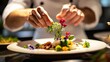 © shobakhul - A Chef Adding Flowers To Food For Plating Perfection