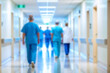 © ATRPhoto - blurred for background. blurred figures of doctors and nurses in a hospital corridor. Doctors and nurses walking in hospital hallway. blurred motion. Moving human figure in the clinic corridor