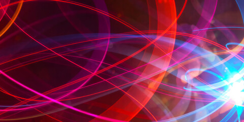 Wall Mural - abstract image showing colorful light streaks against a dark background with light burst