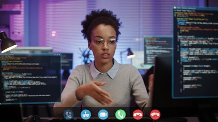 Focused coder collaborating remotely on cybersecurity during video conference