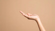 © Hyejin Kang - Close-up image with only empty palms of a woman against a beige background.