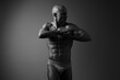 © SHOTPRIME STUDIO - Black and white image of a muscular man posing confidently, showcasing his well-defined physique and strength. A powerful visual representation of fitness and determination.