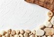 © Nopphawan - White textured backdrop, rustic wooden element, smooth beige stones,  organic,  surface