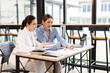 © David - Portrait of Two casual asian business women at work.doing planning analyzing the financial report, business plan investment, finance analysis concept