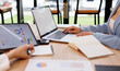 © David - Team of confident business people point to graphs and charts to analyze market data, investor working start up project for strategy plan with document.