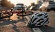 © Abd - A soiled bicycle helmet lies on the asphalt near a fallen bicycle, amidst blurred cars in the background; suggesting an accident at sunset