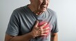 © Rini - Senior man experiencing intense chest pain, clutching his heart with a pained expression.
