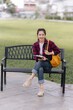 © Wicitr - Smiling Young Woman Sitting on Park Bench