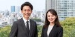 © Oleksandr - Smiling Professionals in Cityscape Setting: A businessman and businesswoman posing with a dynamic urban backdrop, exuding confidence and corporate appeal.