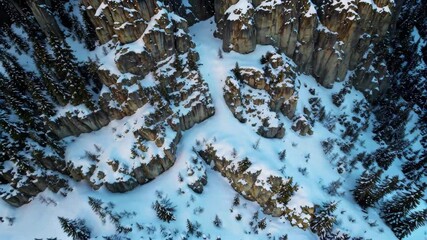 Wall Mural - aerial view of a snowy mountain with a small stream of water
