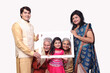 © Pix4Ads - Indian happy family holding white empty board isolated in white background. wearing traditional dresses and looking in front of the camera. festive creative concept theme.