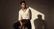 © Gita - Man posing in white shirt with shadow on the wall behind