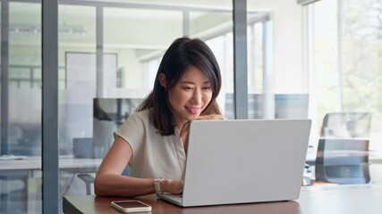 30s middle-aged woman using computer technology app for banker financial work online. Mature Asian professional it specialist businesswoman working on laptop pc sitting at desk in office. Copy space