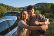 © Miljan Živković - young man and woman on a break from the road take a self portrait