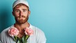 © svastix - This striking portrait features a thoughtful man holding pink flowers, set against a vibrant blue background, symbolizing emotions, beauty, and sensitivity in human connection.