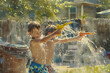 © Dream - kids playing with water guns, backyard, bright summer light, fun mood
