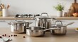 © samback - A Culinary Collection: Stainless Steel Cookware Set on a Modern Kitchen Counter
