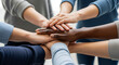 © noz-studio - Group of diverse people stacking hands together in a show of unity and teamwork concept image close up view