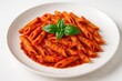 © Jelena - Gourmet Penne alla Arrabbiata pasta in spicy tomato sauce with fresh herbs isolated on white background for Italian cuisine marketing
