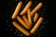 © Bijac - Dynamic golden french fries captured mid-flight against dramatic black background with motion effect