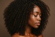 © Bijac - Natural textured afro hair styled in elegant spiral curls isolated against pristine white studio background
