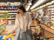 © Apichat - woman and a child are shopping in a grocery store