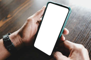 Close-up of a man's hands holding a smartphone with a blank white screen. Ideal mockup template for mobile application or website interface display.
