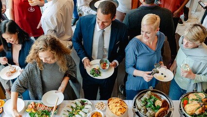 Wall Mural - diverse group enjoying buffet. people gather around buffet table. buffet includes various dishes. so