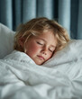 © Thanakorn - peaceful little blonde girl sleeping in cozy bed, surrounded by soft white bedding. serene atmosphere captures innocence of childhood