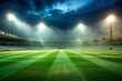© Nazmul - Empty stadium at night with bright floodlights illuminating green field