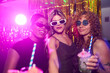 © alvaro - Cheerful diverse women enjoying nightlife, posing at trendy disco party