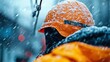 © Larisa AI - A dedicated construction worker wearing a bright orange helmet and jacket stands amidst falling snow, symbolizing resilience and hard work despite harsh winter conditions.