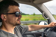 © puhimec - Driver profile. Man behind the wheel. Sunglasses in vehicle