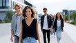 © pkproject - A group of young people walking down a modern city street. long_title:A diverse group of young adults casually walking together down a busy city