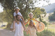© Halfpoint - A portrait of young family with small children in sunny summer nature.