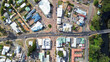 © Sam Jeffs - Top down Arial view of a small rural town centre with cars on the road, roof tops of homes and businesses, a river with park and trees. Main road with 4 Way intersection. Denmark Western Australia