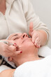 © Juanma Cuevas - Beautician performing microdermabrasion treatment on mature woman face
