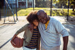 © Davor - Grandfather and grandson bonding on basketball court outdoors
