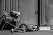 © Pixel-Shot - Homeless man with shopping cart and cardboard sleeping on street