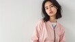 © Atmospheric stock - Young asian female in pink jacket posing against white background