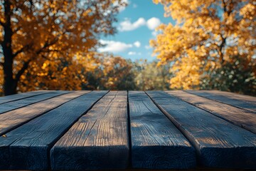 Wall Mural - Autumn Rustic Charm: Wooden Table with Fall Foliage and Blue Sky Backdrop for Prints or Posters