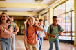 © Drazen - Happy school kids having fun while running through hallway.