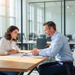© InfinityVisuals - Consultation and Collaboration: A business professional and a client engrossed in paperwork, engaged in a productive consultation session. Captured within a modern and bright office setting.