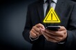 © Art by Saiful - Vibrant photo of businessman using a mobile phone with a warning sign and exclamation mark icon on a black background, a business concept for online security or a cyber attack.
