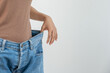 © Shisu_ka - Women showing results of diet. Beautiful shape. female have a reduced waist size after under going a weight loss corse. can not wear jeans due to weight loss. balance, control, routines, exercise.