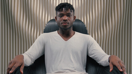 futuristic confident serious gamer programmer hacker african american man guy male sitting in chair 