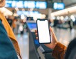 © IsyrafSyafi - Woman holds a smartphone at the airport