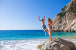 © Tropical studio - Happy kids jump into turquoise sea water at Kaputas beach, Lycia coast. Summer relaxing day at family vacation in Mediterranean Sea, Kas, Antalya region, Turkey